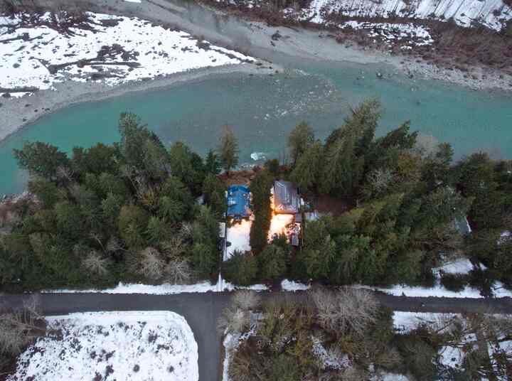 Aerial view of the property beside the river in snow