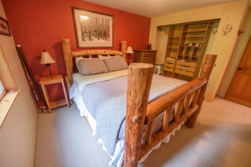 Bedroom with tall log bed posts