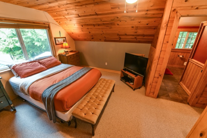 Bedroom with television and windows