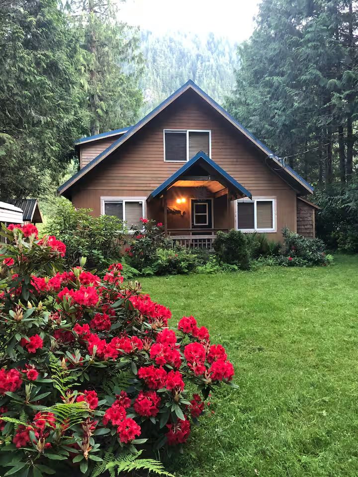 The chalet behind rhododendrons in full red bloom