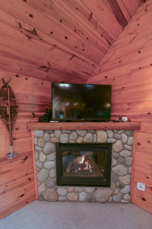 Stone fireplace with television above