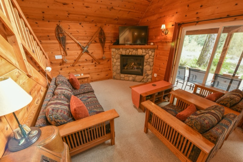 Living room seating around the stone fireplace