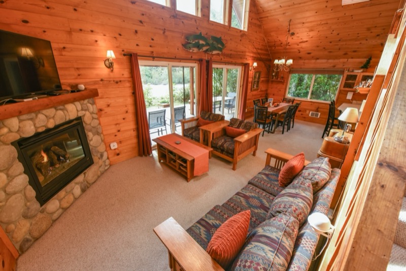 Hearth with couch and windows to the deck